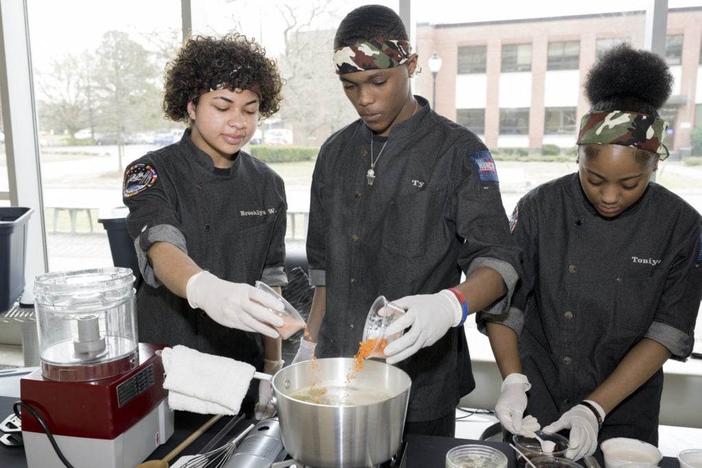 The Phoebus High School culinary team working together to prepare their dish for the judges at the HUNCH Culinary Challenge at NASA's Langley Research Center.
Credits: NASA / Mark Knopp